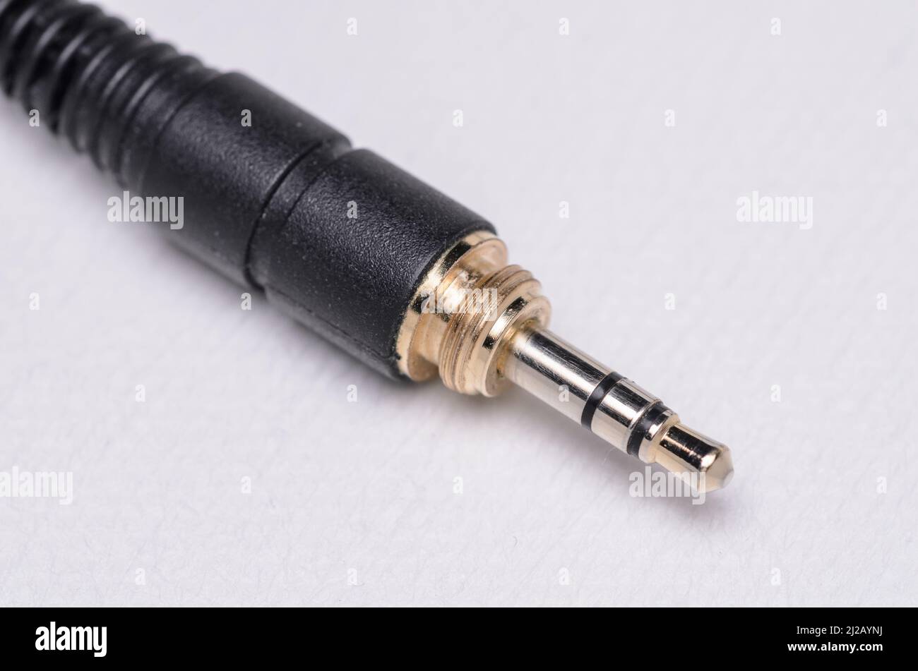 3.5mm stereo headphone jack connector and cable for analog audio signals on white background Stock Photo