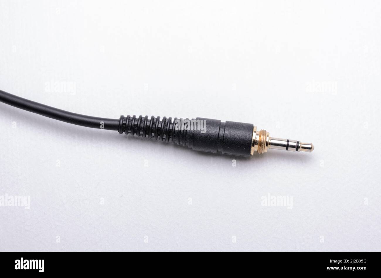 3.5mm stereo headphone jack connector and cable for analog audio signals on white background Stock Photo