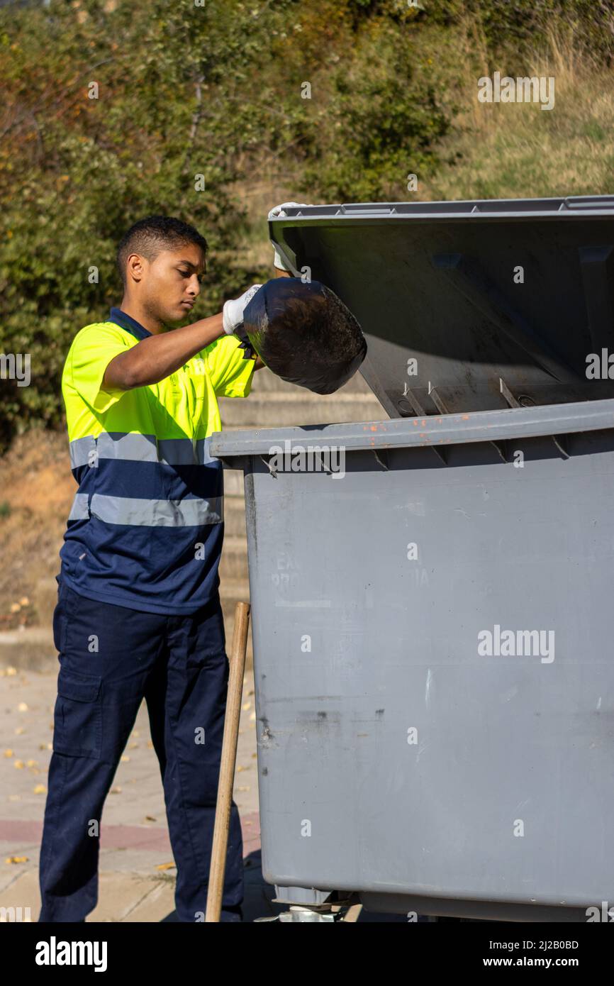 Worker throwing garbage bin hires stock photography and images Alamy
