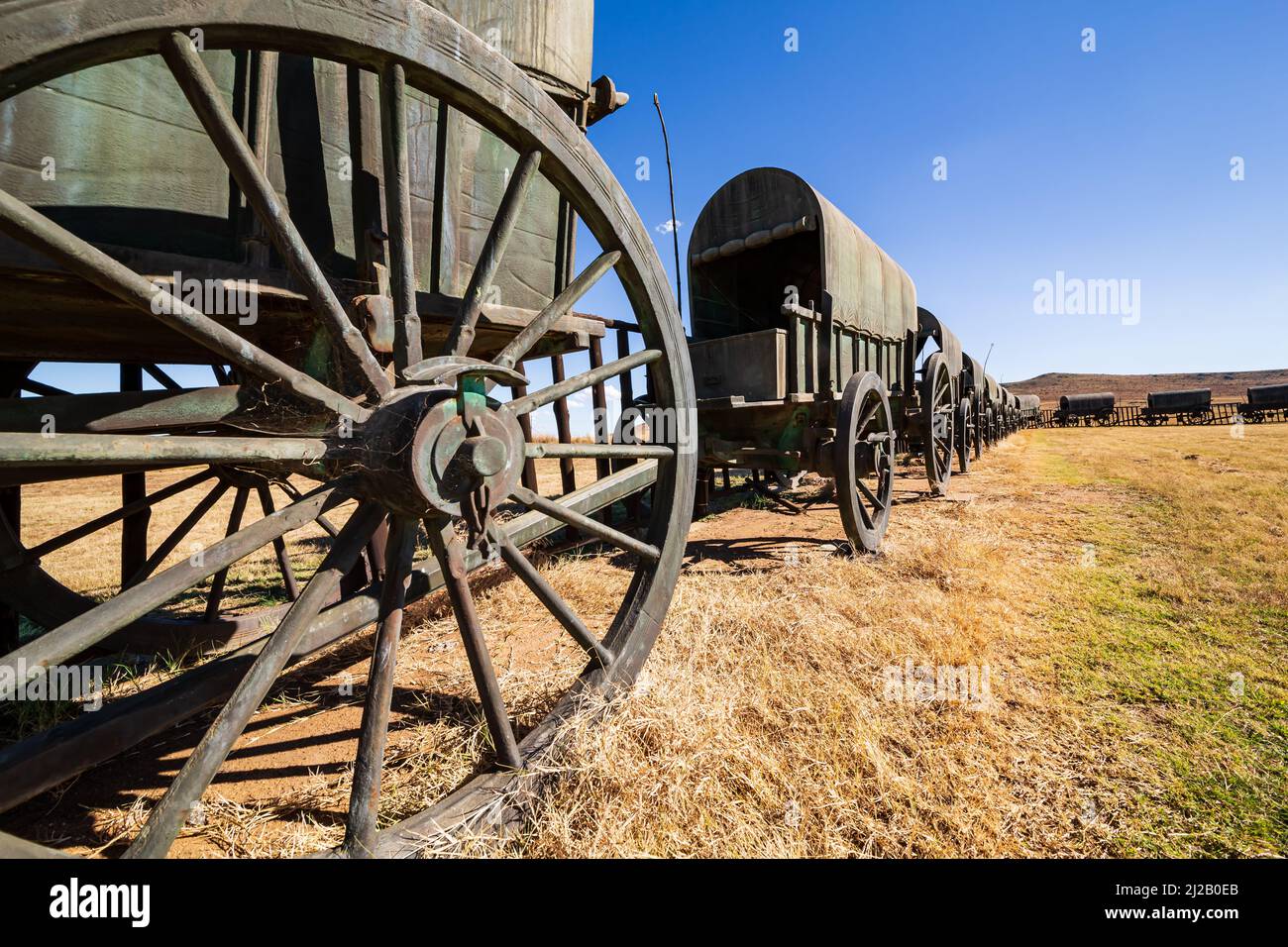 Circle of 64 replica Voortrekker wagons cast in bronze at Blood River Heritage Site, KwaZulu-Natal, South Africa Stock Photo