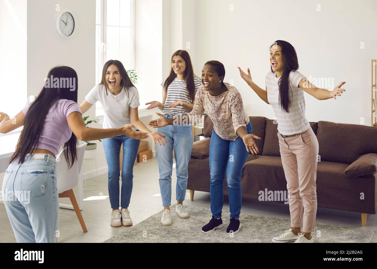 Overjoyed diverse girls play game at home Stock Photo