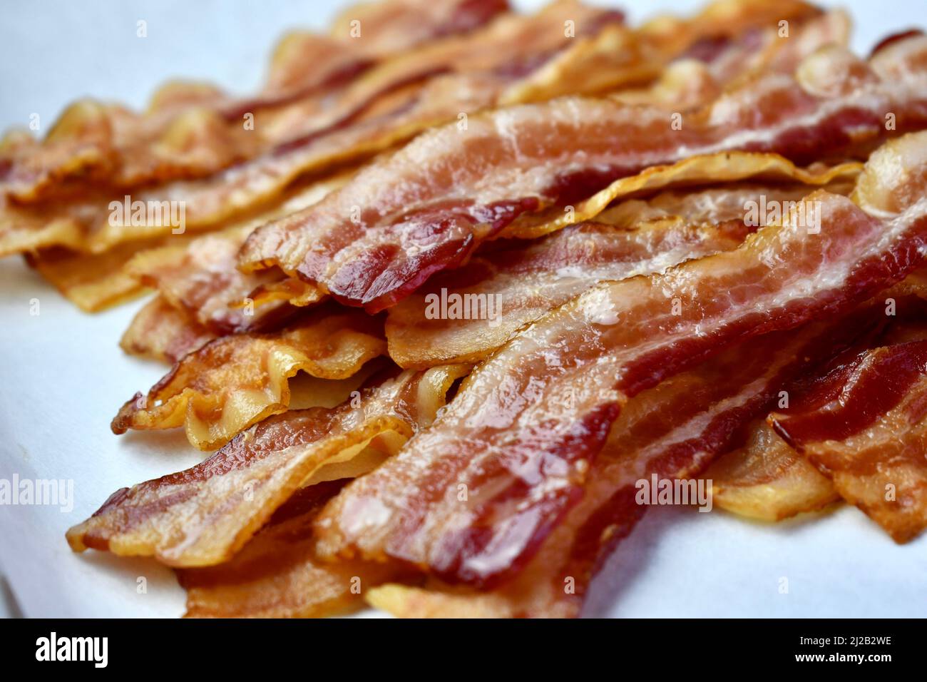 Bacon rashers on parchment lined baking pan Stock Photo