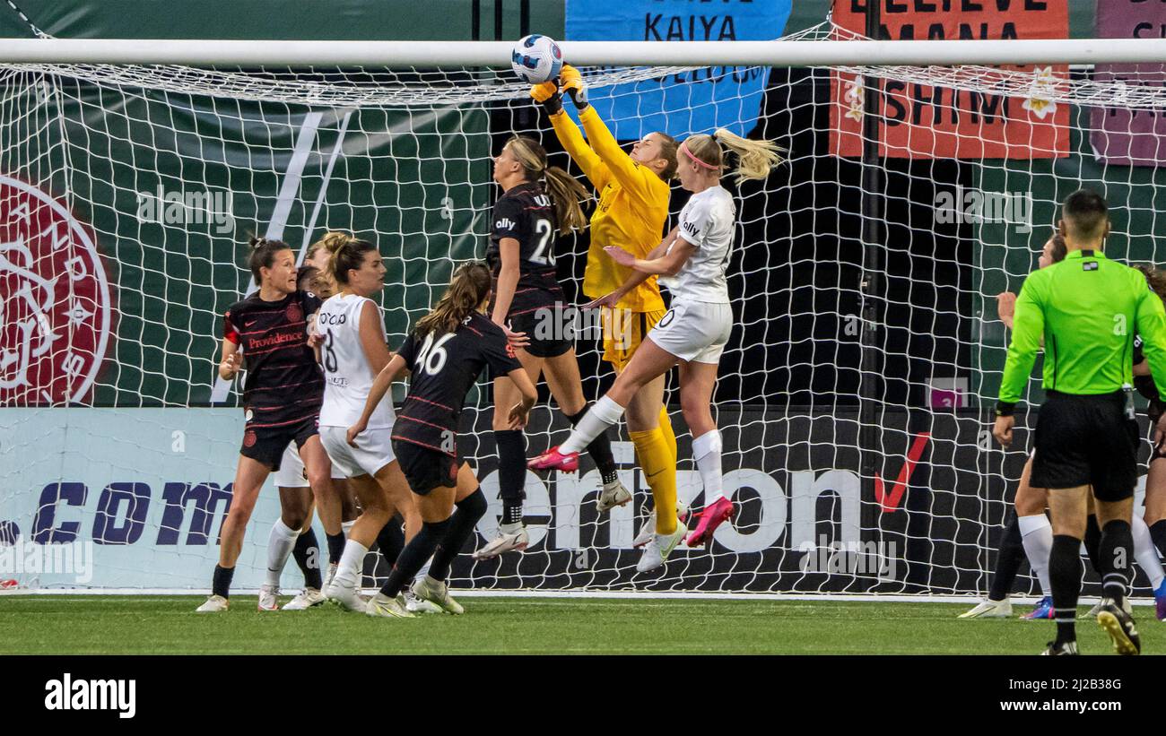 Thorns goalie Bella Bixby punches an Angel City corner kick to safety