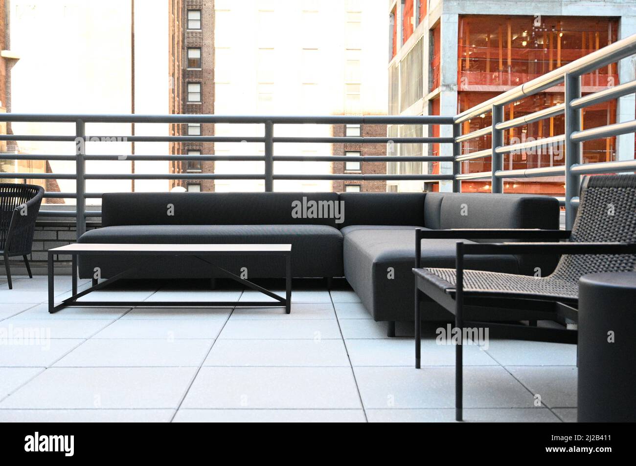 A modern balcony design with gray sofas and a table Stock Photo