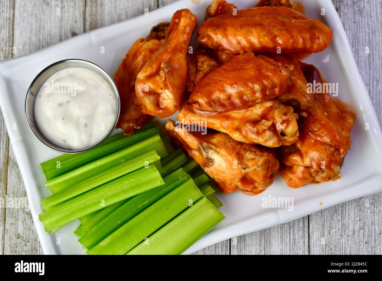 Hot wings with celery sticks and ranch dressing, view from above Stock