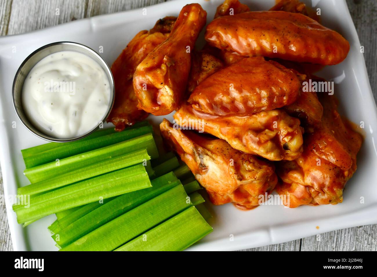 Hot wings with celery sticks and ranch dressing, view from above Stock
