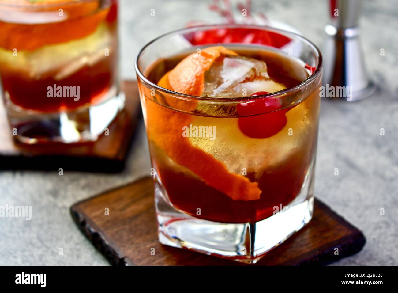 Old Fashioned Cocktail With Orange Peel Garnish And Maraschino Cherry old-fashioned-cocktail-with-orange-peel-garnish-and-maraschino-cherry