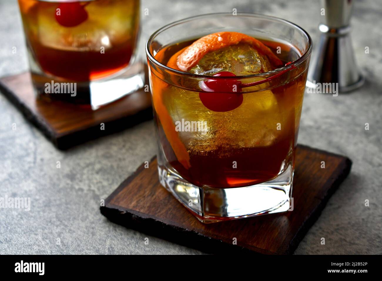 Old fashioned cocktail with orange peel garnish and maraschino cherry Stock Photo