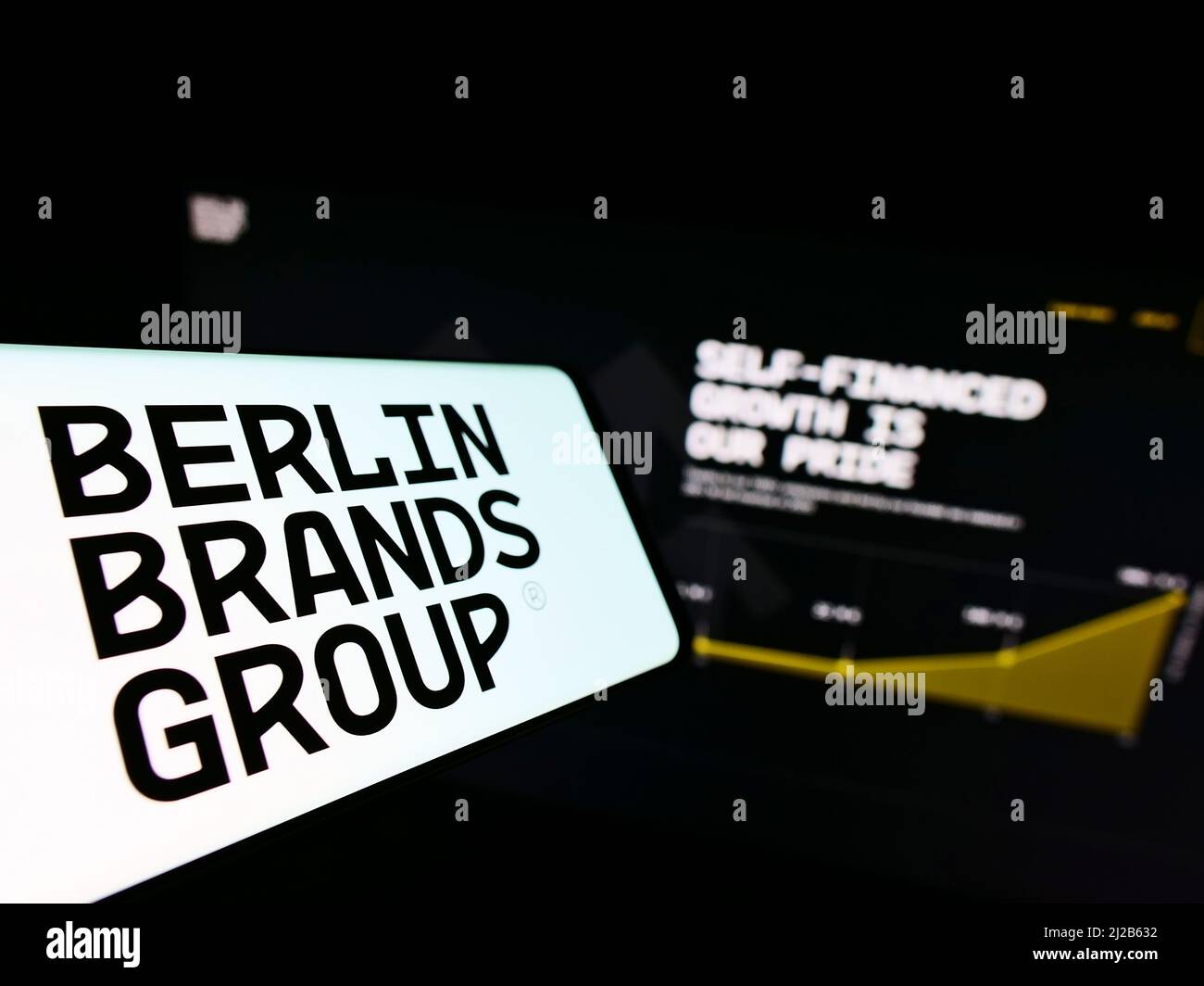 Cellphone with logo of company Chal-Tec GmbH (Berlin Brands Group) on screen in front of business website. Focus on center of phone display. Stock Photo