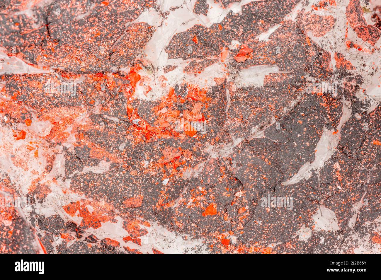 Crafter or artists dust sheet covered by flaking, sprayed, orange and black paint. For DIY paint job, peeling paint, making a mess of things. Stock Photo
