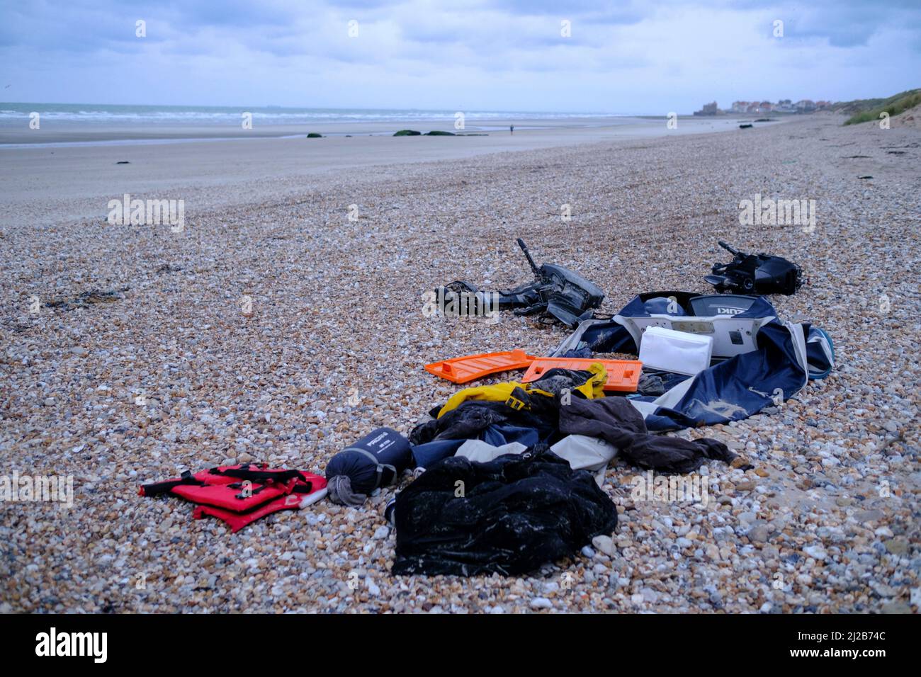 Refugees and migrants in the Hauts-de-France region (northern France), on November 26, 2021: pieces of boat, engine and refugees’ personal belongings Stock Photo