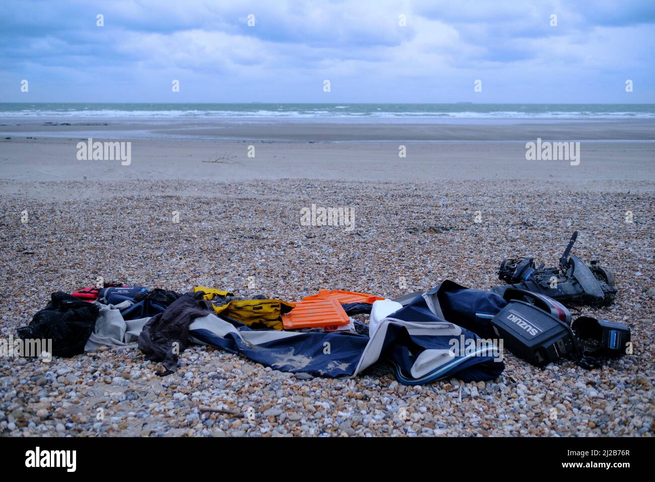 Refugees and migrants in the Hauts-de-France region (northern France), on November 26, 2021: pieces of boat, engine and refugees’ personal belongings Stock Photo