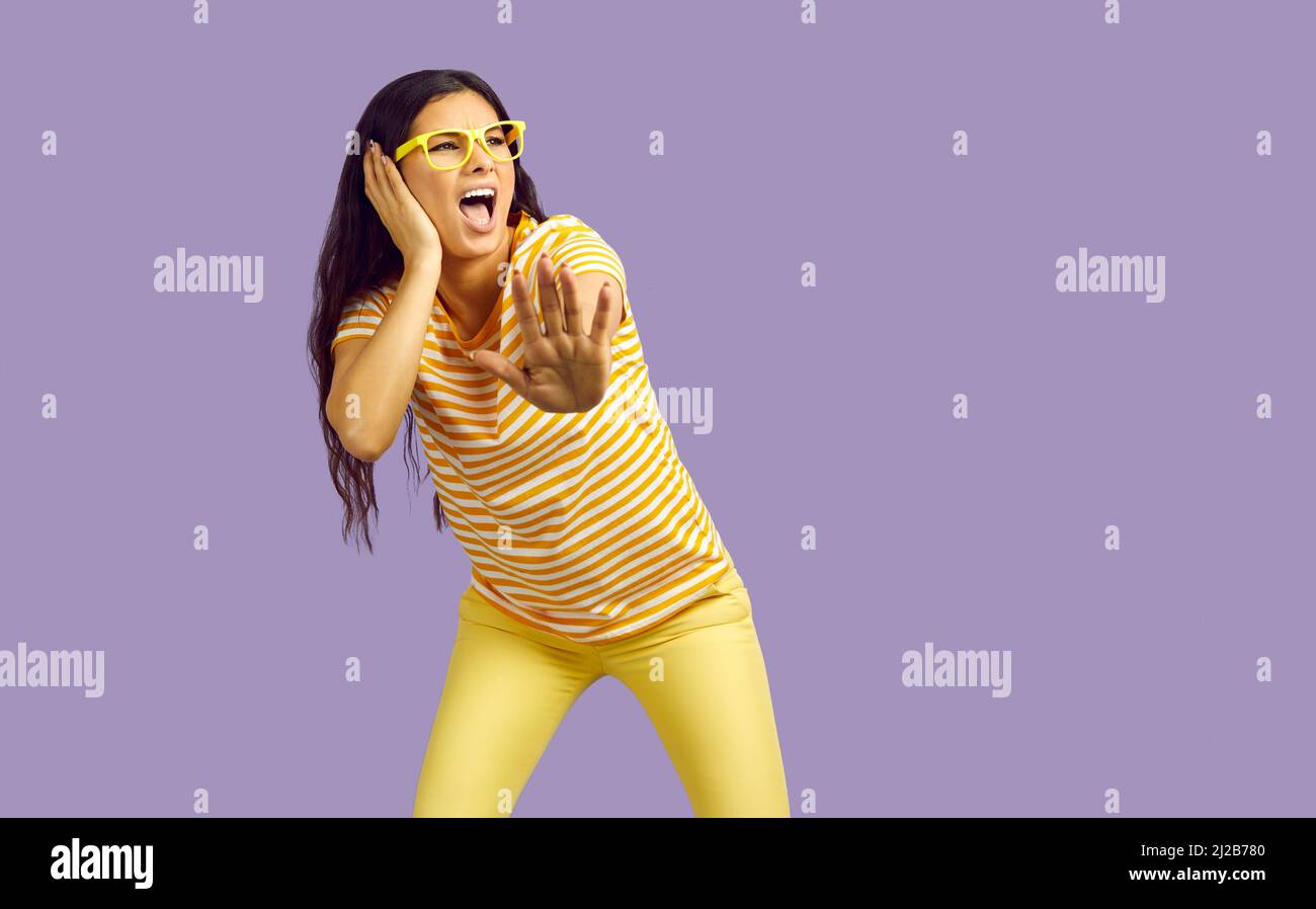 Funny crazy woman listening to loud music, dancing, singing, shouting and having fun Stock Photo