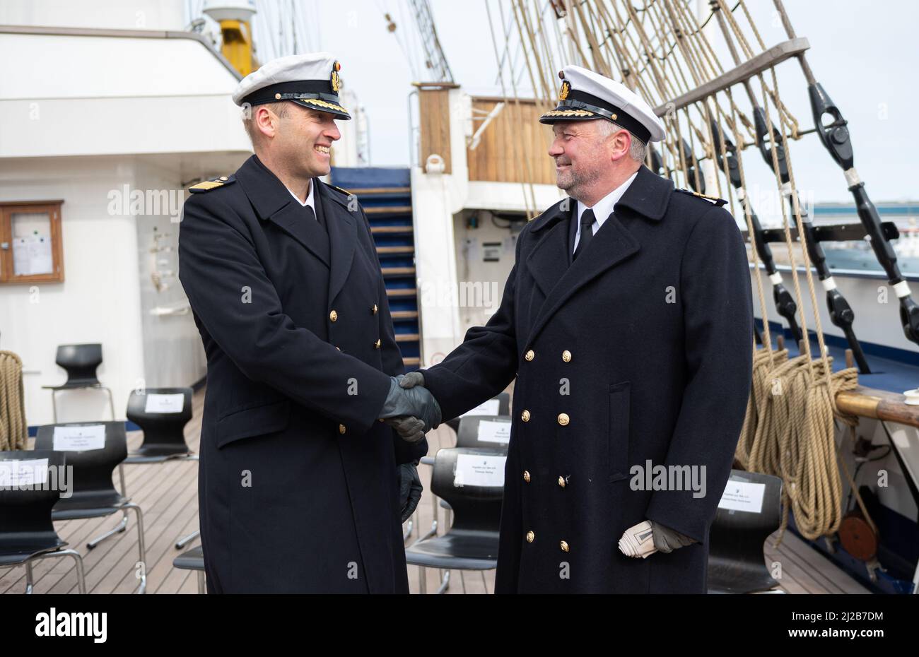 Kiel, Germany. 31st Mar, 2022. The new commander of the Gorch Fock, Captain (See) Andreas-Peter Graf von Kielmansegg (l), and his predecessor Captain (See) Nils Brandt, stand on board the ship after the handover of command. After eight years, Captain Brandt has handed over command of the sail training ship Gorch Fock to Captain Graf von Kielmansegg. Credit: Daniel Reinhardt/dpa/Alamy Live News Stock Photo