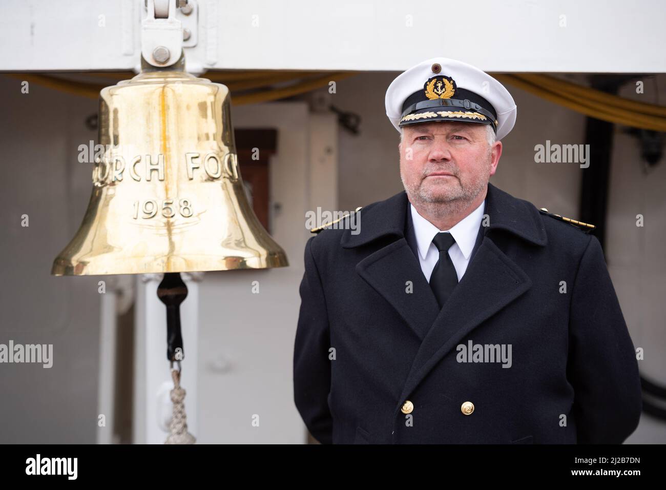 Kiel, Germany. 31st Mar, 2022. Captain (See) Nils Brandt stands on board the Gorch Fock during the handover of command to his successor. After eight years, Captain Brandt has handed over command of the sail training ship Gorch Fock to Captain Graf von Kielmansegg. Credit: Daniel Reinhardt/dpa/Alamy Live News Stock Photo