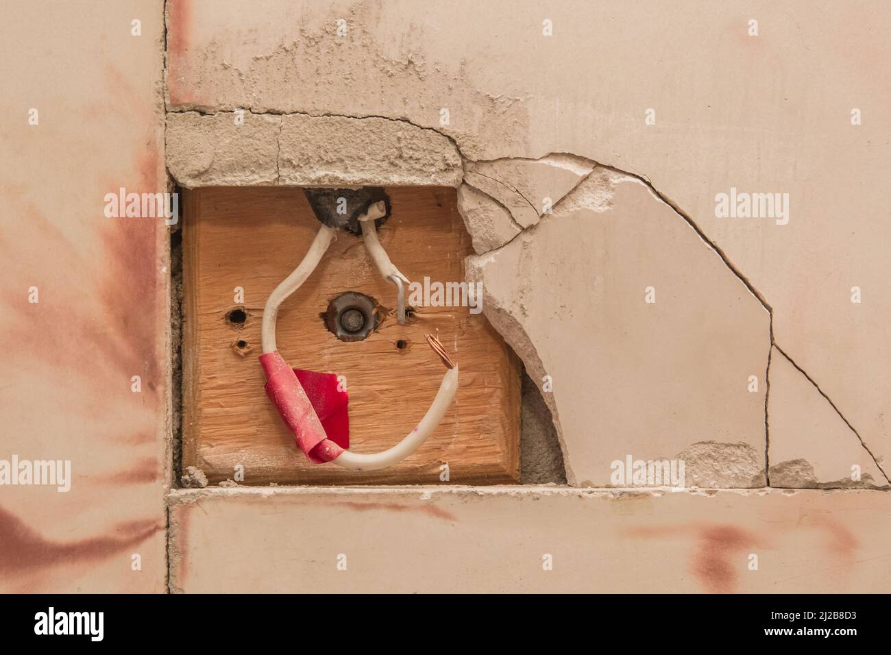 Old socket and wire electrical concept need to repair the power of voltage wall industry. Stock Photo