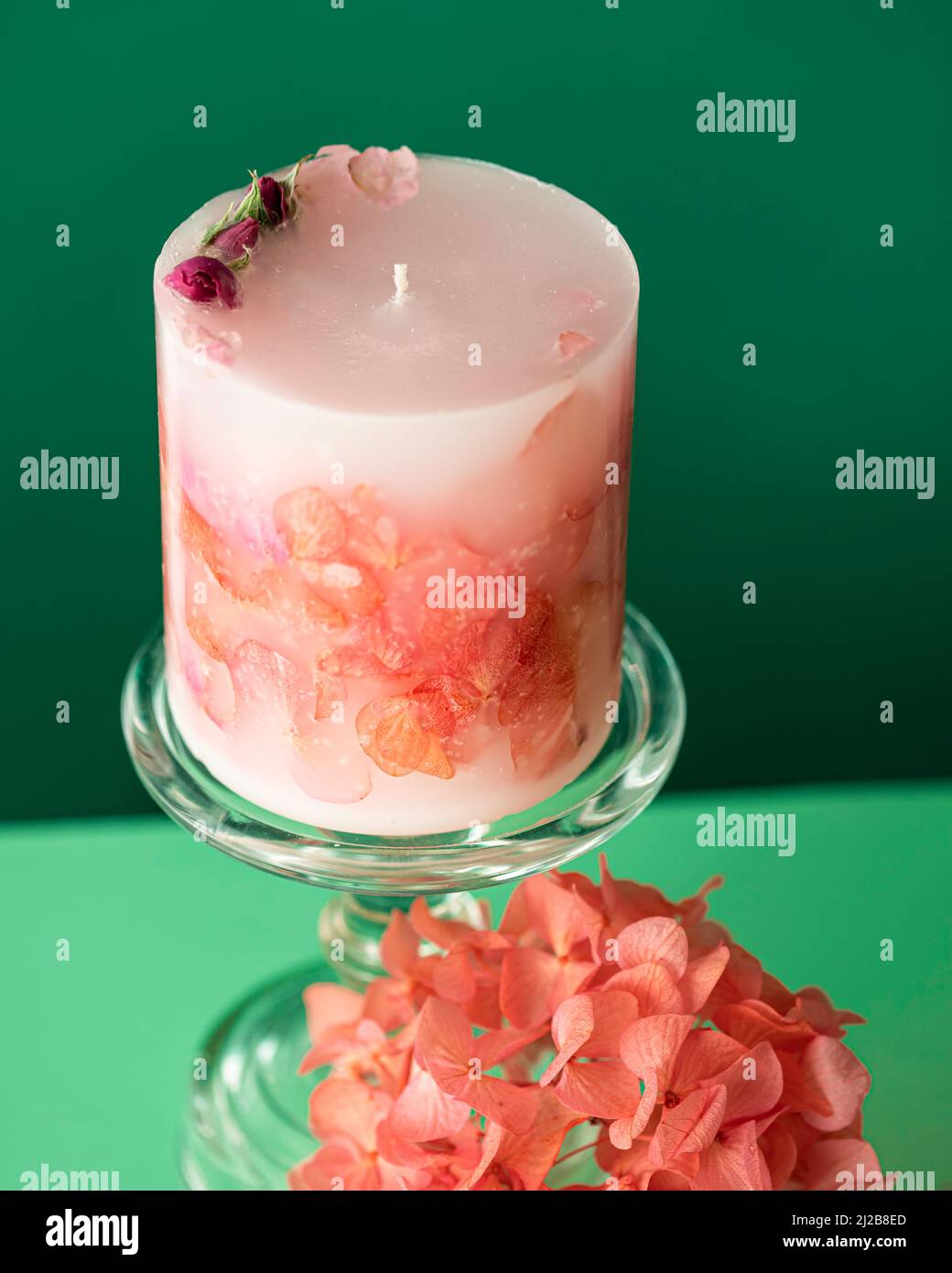 Handmade candles of a unique design, with different flowers, dry leaves