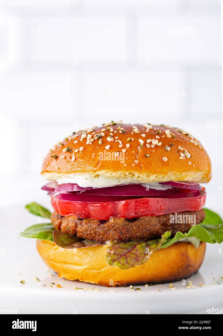 V. Burger Plant based veggie burger with a red heirloom tomato, red onion and ...