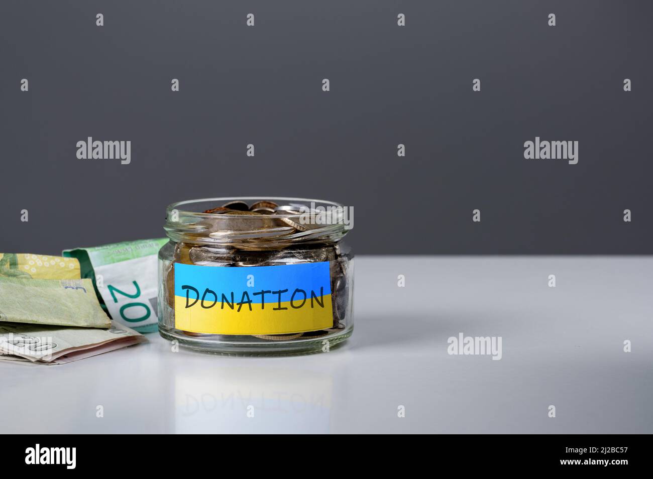 donation for ukrainian refugees. Donation for Ukraine concept. Help and financial assistance to Ukraine. donation jar with Ukrainian flag. Ukrainian w Stock Photo