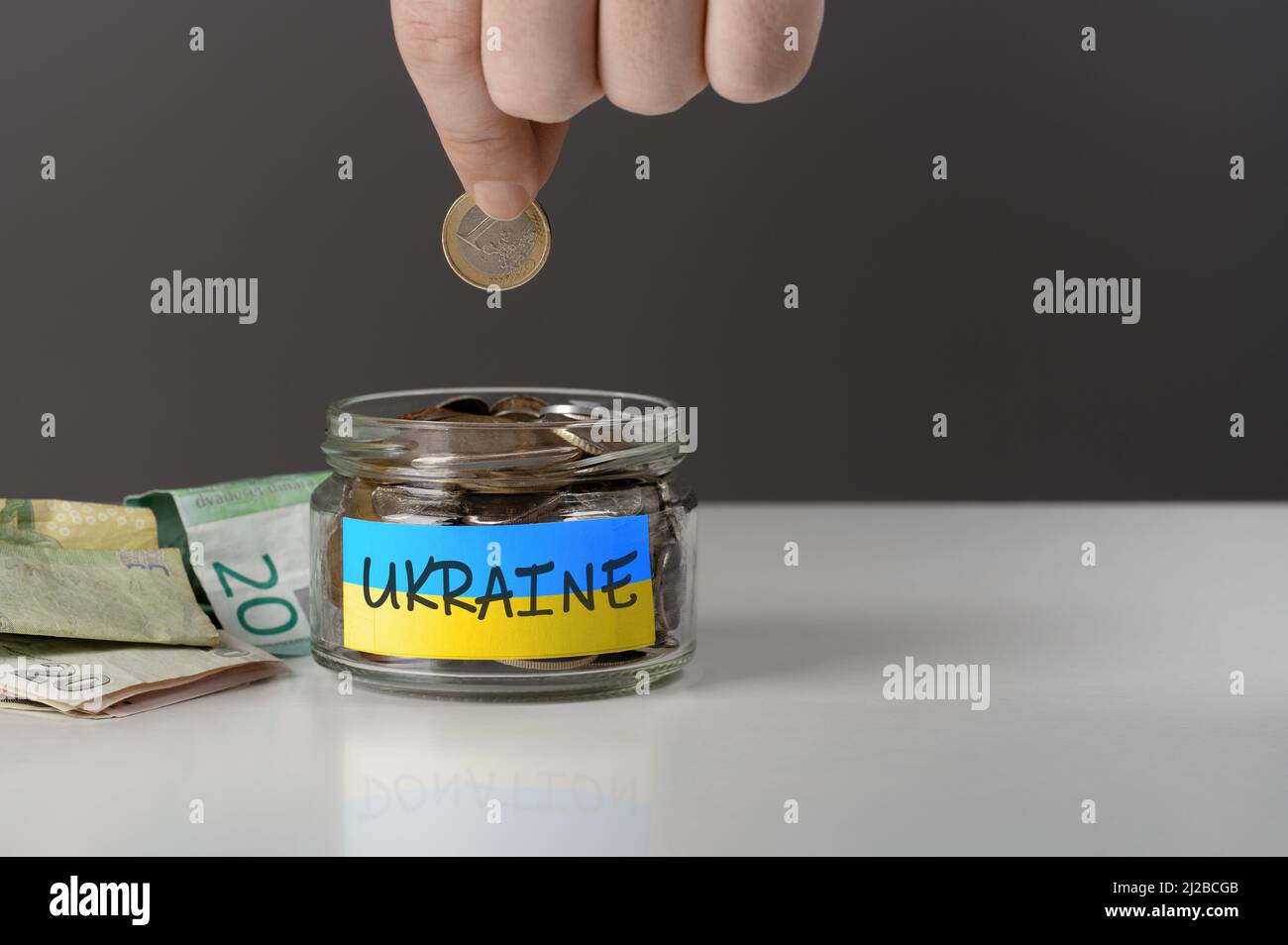 donation for ukrainian refugees. Donation for Ukraine concept. Help and financial assistance to Ukraine. donation jar with Ukrainian flag. Ukrainian w Stock Photo