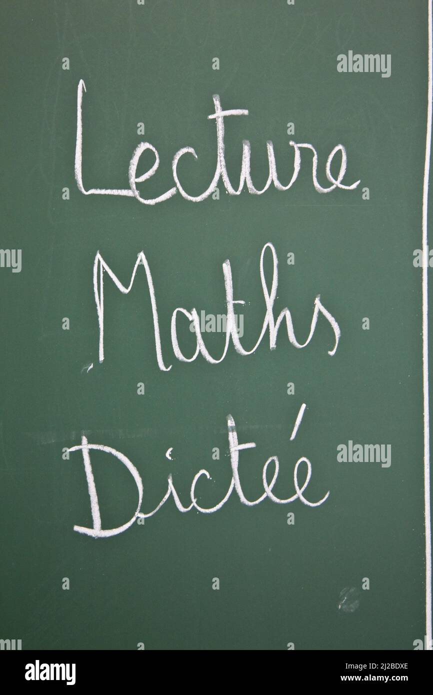 Reading, maths and dictation on the board of a classroom in a primary