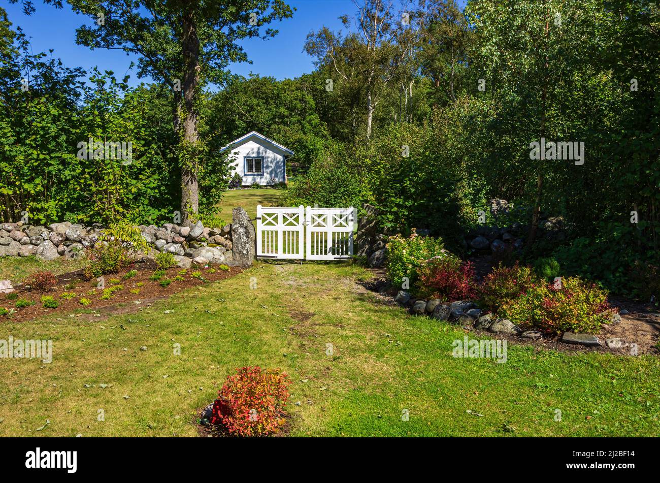 Idyllic property with small cottage and garden gate situated in the green, South Koster Island, Bohuslän, Västra Götalands län, Sweden. Stock Photo