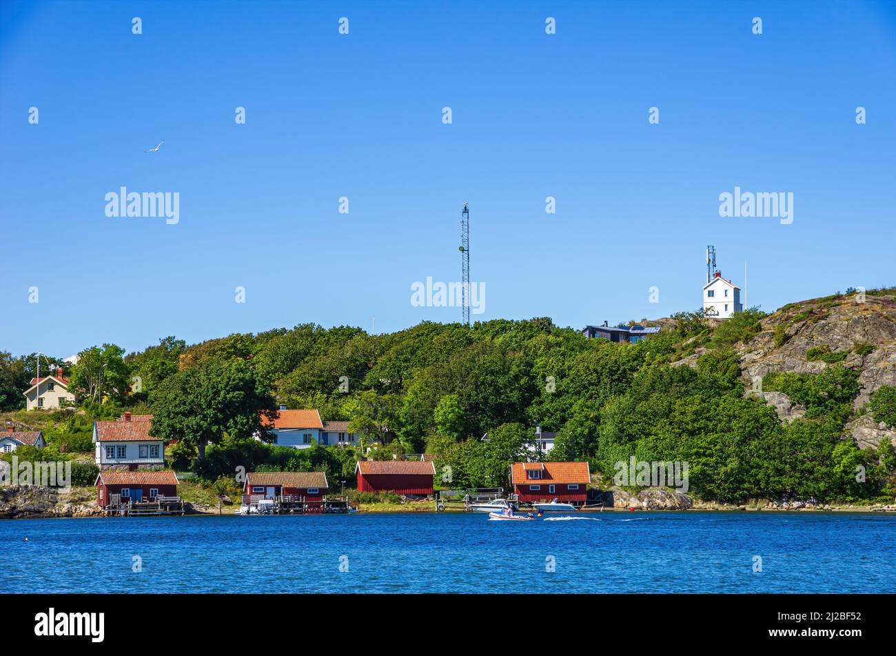 Picturesque coastal landscape with boat sheds and cottages, South coast of North Koster Island, Bohuslän, Västra Götalands län, Sweden. Stock Photo