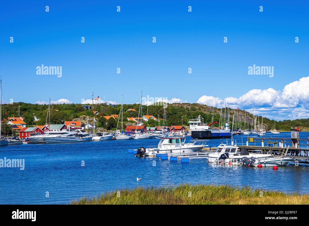 South Koster Island, Bohuslän, Västra Götalands län, Sweden - August 11, 2016: Jetty with boats and boat sheds in the village of Langegarde. Stock Photo