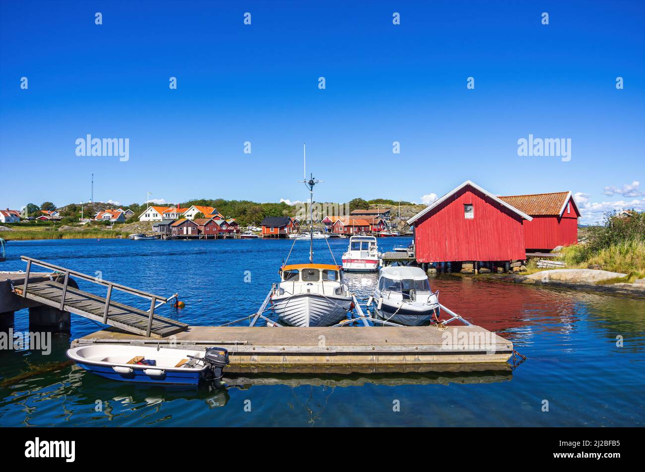 South Koster Island, Bohuslän, Västra Götalands län, Sweden: Jetty with boats and boat sheds in the picturesque village of Langegarde. Stock Photo
