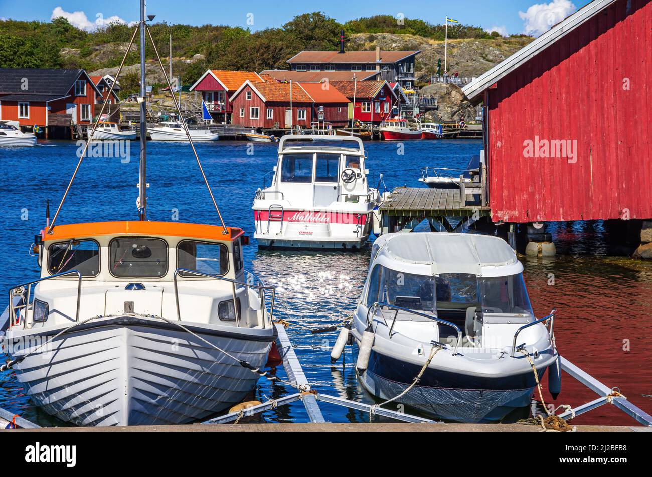 South Koster Island, Bohuslän, Västra Götalands län, Sweden: Jetty with boats and boat sheds in the picturesque village of Langegarde. Stock Photo