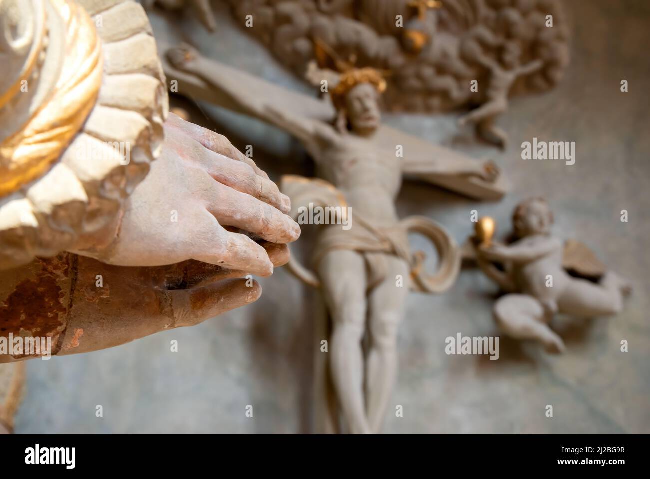Praying hands with jesus christ on cross in background Stock Photo