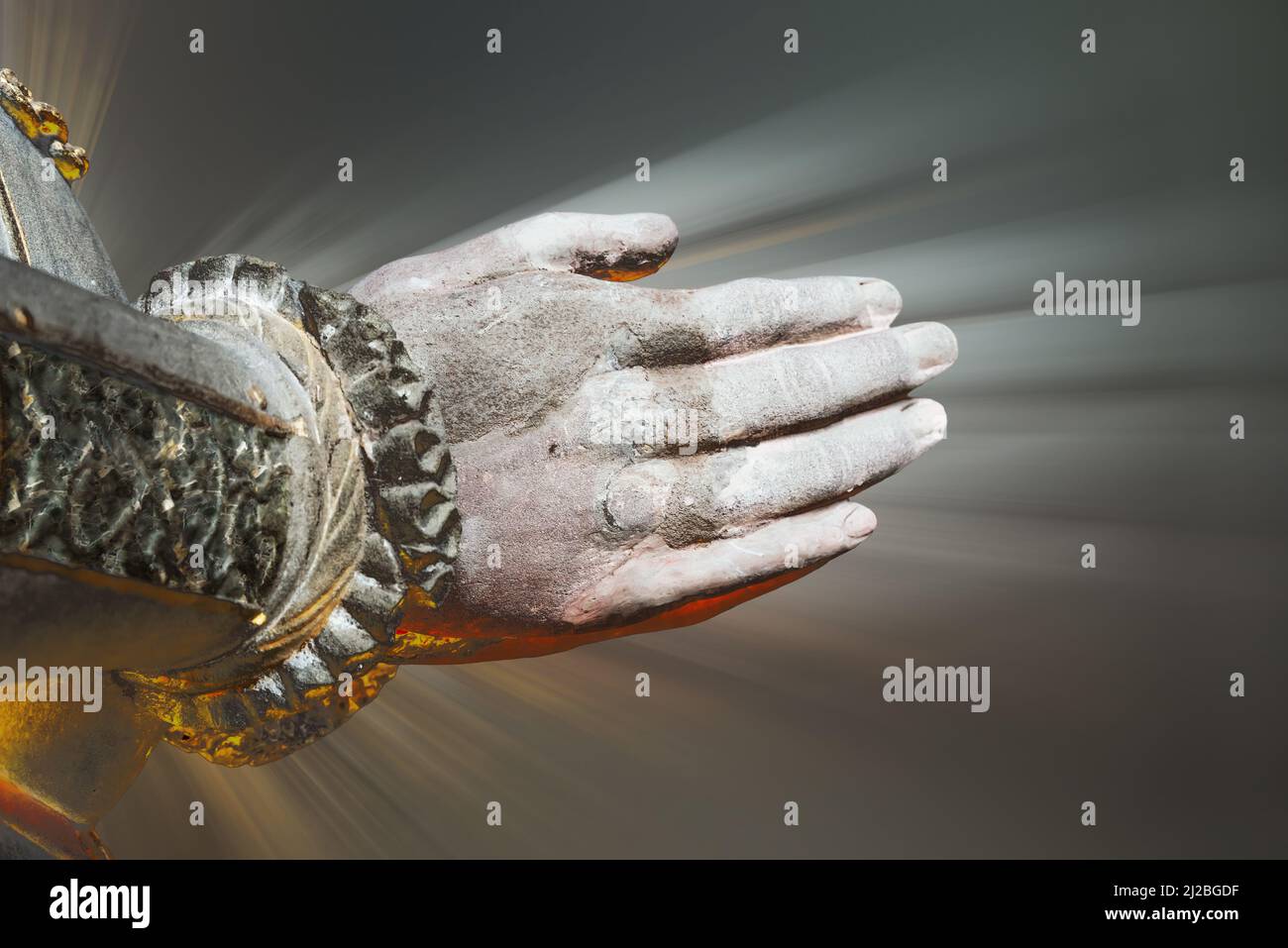 Praying hands with rays background Stock Photo
