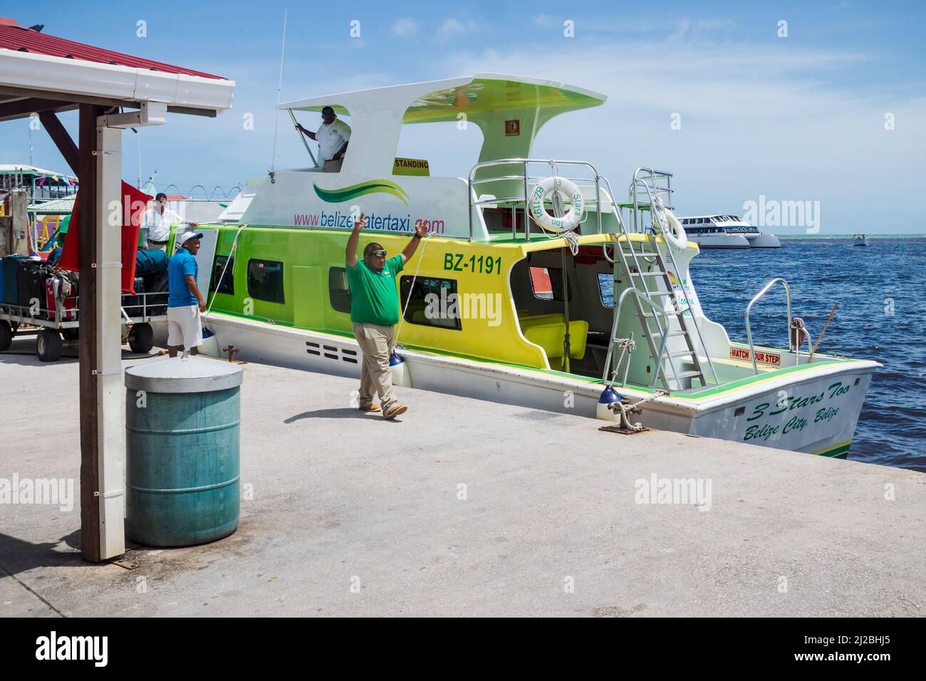 Belize City, Belize - 4 September 2018: Workers of the 'Belize water taxi' having fun before departure at the harbor Stock Photo