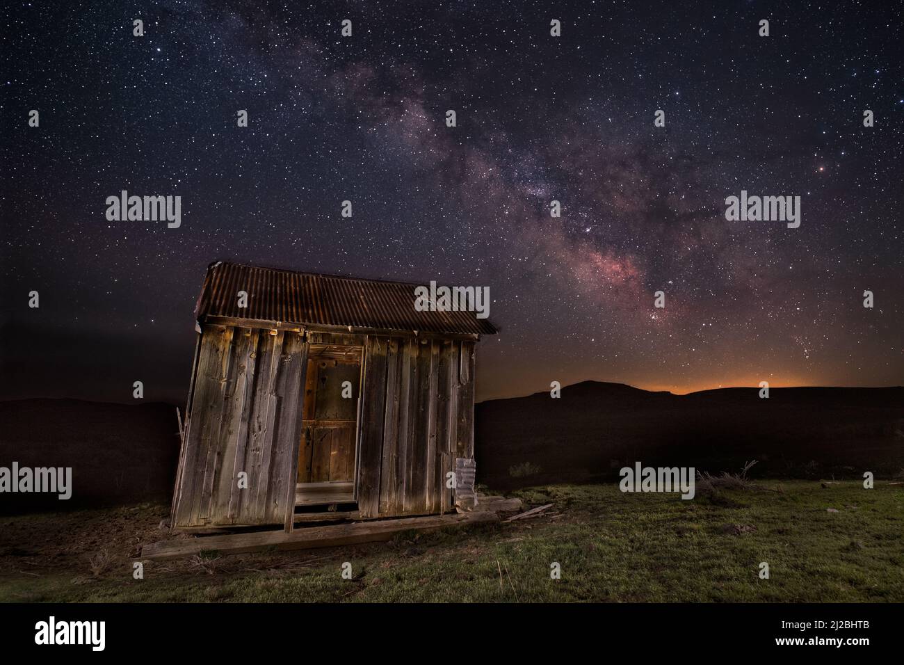 Abandoned shack in the high desert of Lassen County, California, USA.  Photographed at night under the galactic core of the Milky Way. Stock Photo