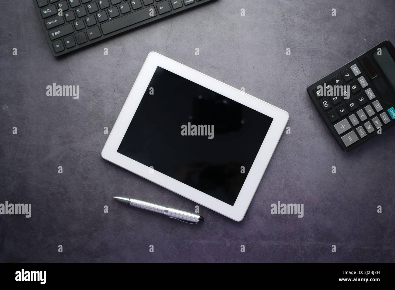 top view of digital tablet with office suppliers on black background Stock Photo