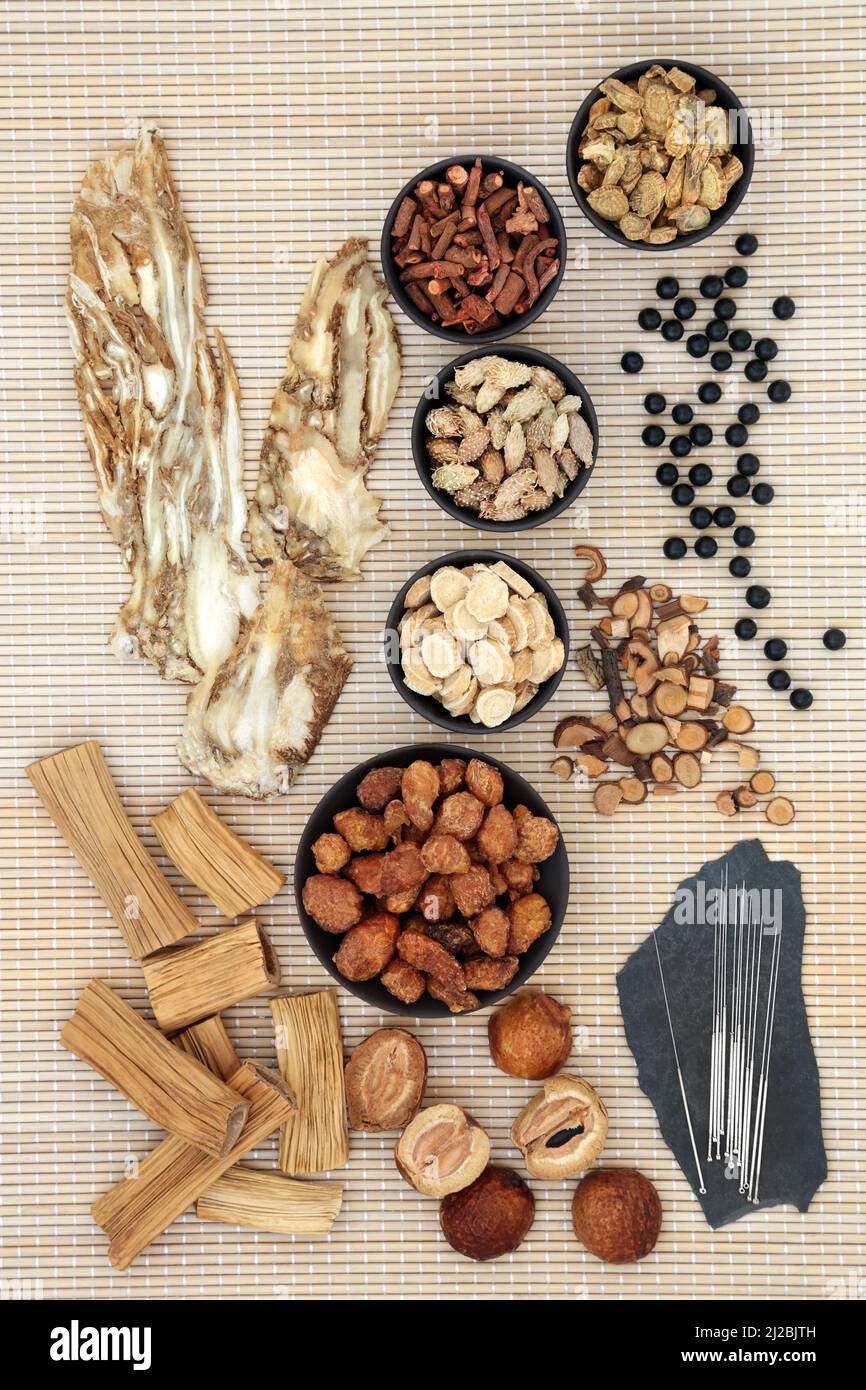 Chinese herbal plant medicine with chi and immune system boosting pills and herbs with acupuncture needles used to treat various illnesses. Alternativ Stock Photo