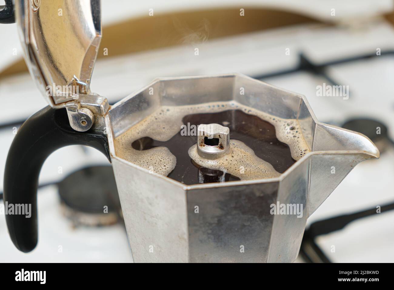 https://c8.alamy.com/comp/2J2BKWD/hot-freshly-brewed-coffee-in-a-geyser-coffee-maker-standing-on-a-gas-stove-2J2BKWD.jpg