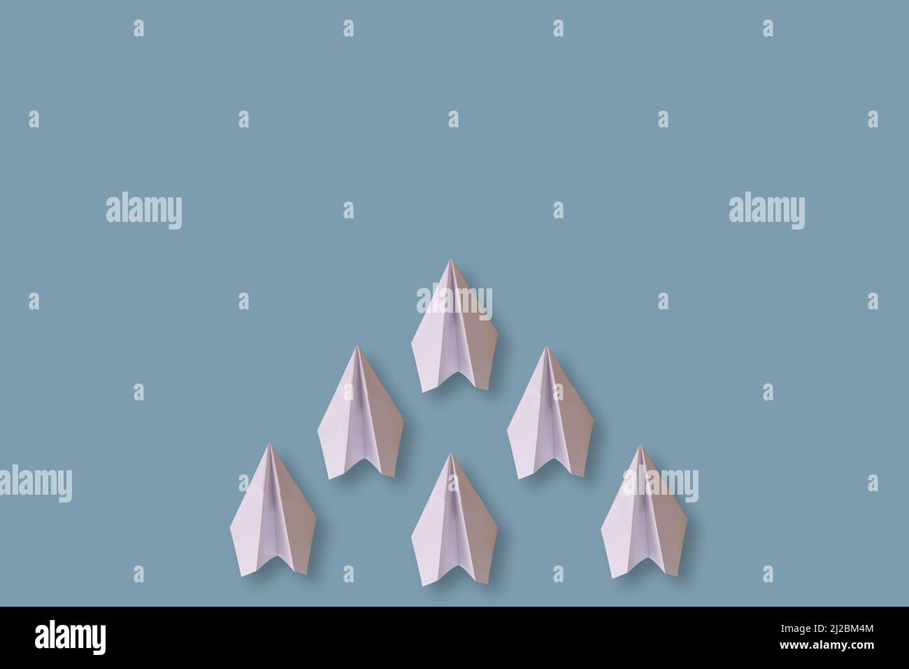 six paper airplanes isolated on a blue background Stock Photo - Alamy