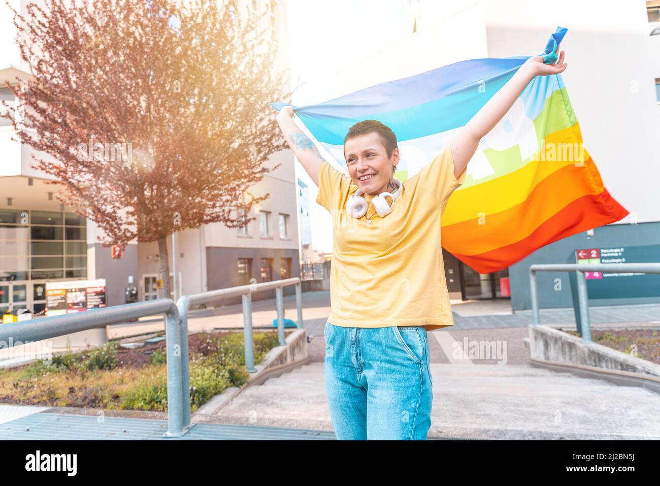 Happy woman with the peace flag is against the war and discrimination Stock Photo