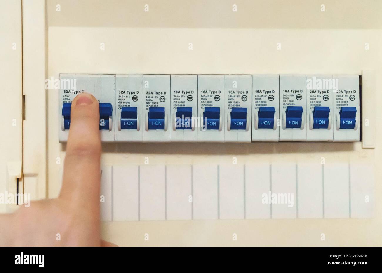 Male hand switching on fuse board Stock Photo Alamy