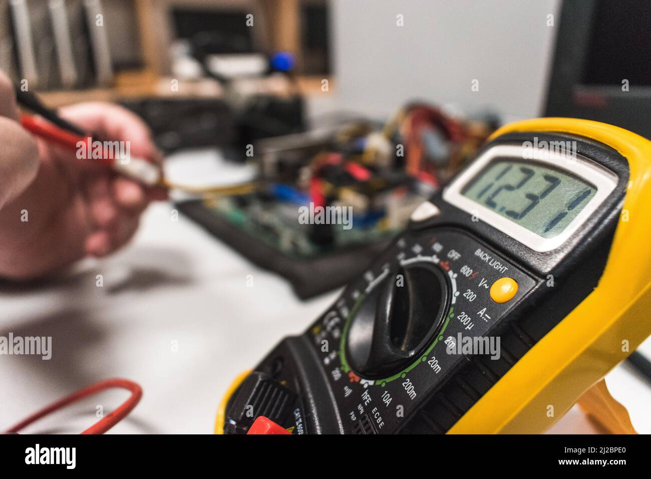 Detail of a multimeter being used by a technical IT on a computer