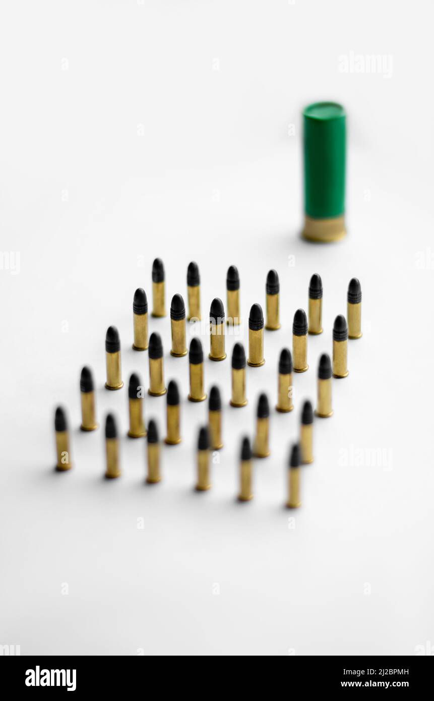 high angle view of bullets near blurred shotgun shell on white ...