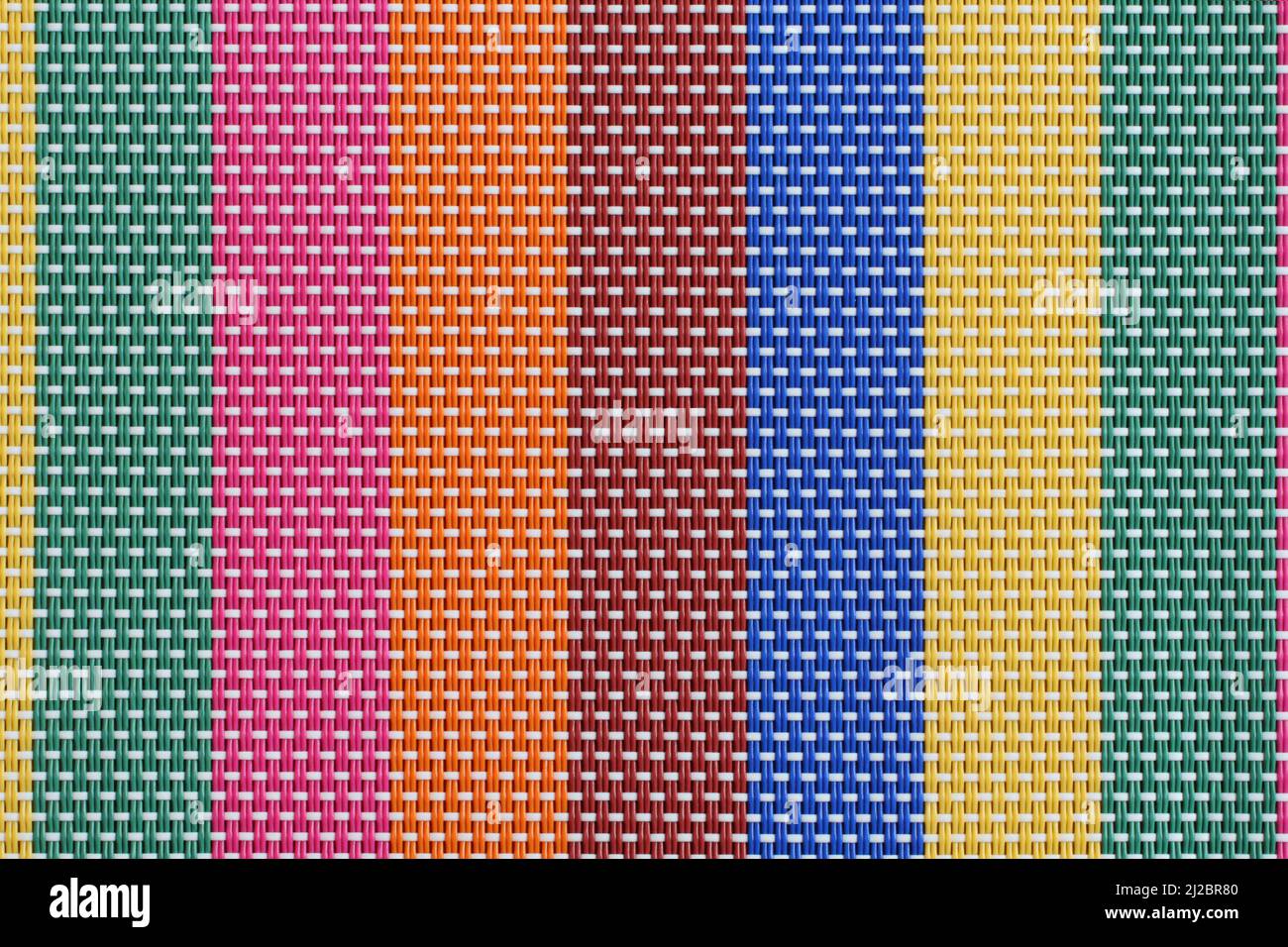 Texture - multi-colored plastic threads intertwined make up the surface for the table. Closeup. Macro. Stock Photo