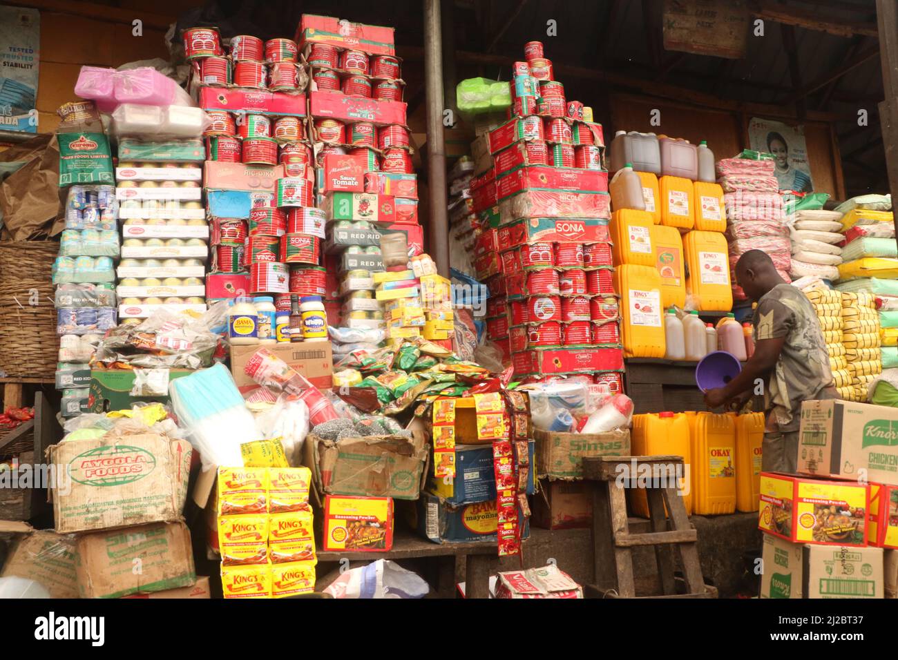 Nigerian people buying and selling food at the market. Lagos, Nigeria