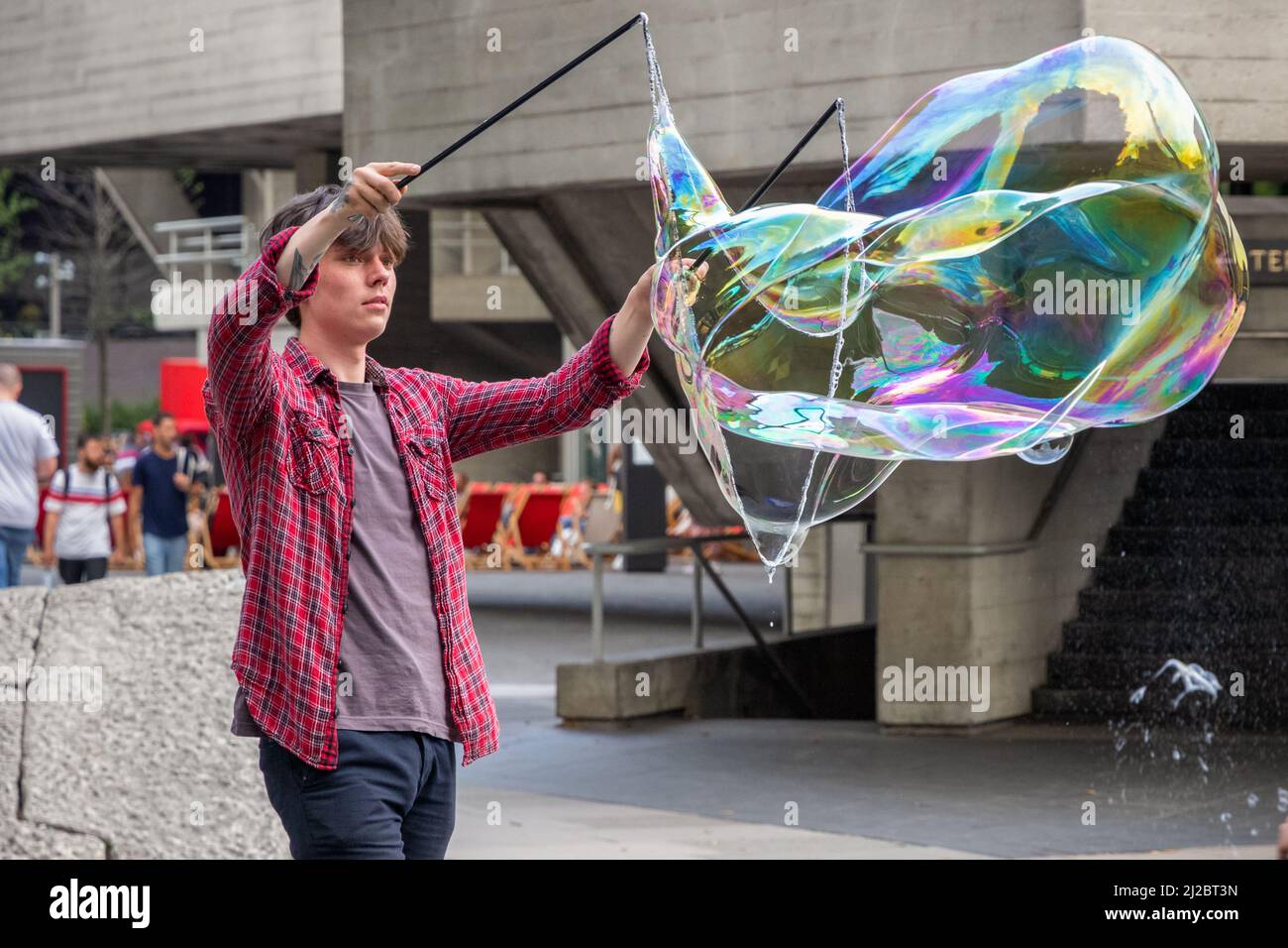 London, UK - 19 July, 2021 - A soap bubble street performer in South Bank area Stock Photo