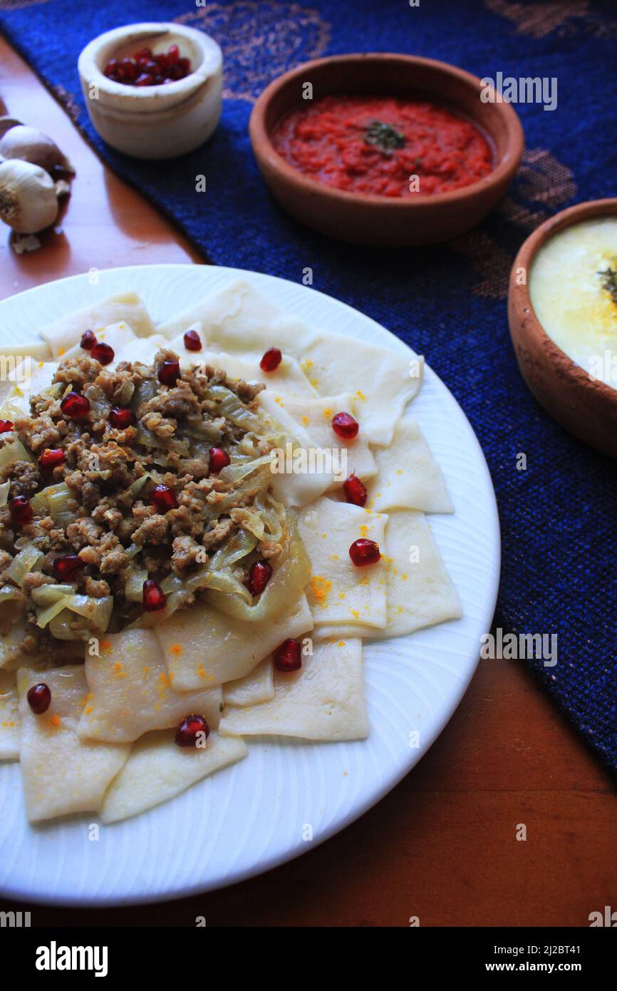Azerbaijani Khingal (Square Handmade Noodles with Ground beef and Garlic Yogurt Sauce) Stock Photo