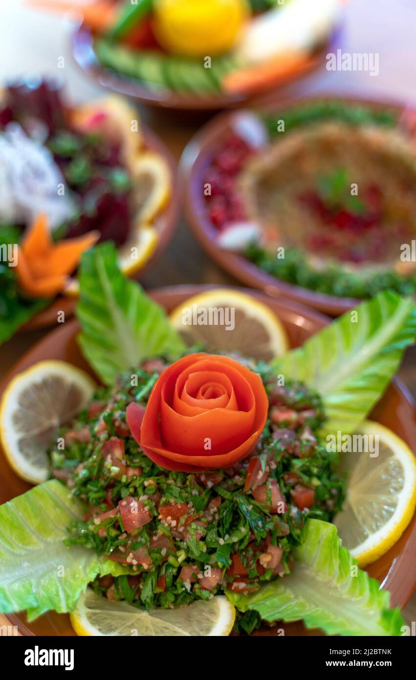 Multiple lebanese appetizers and salads together on the table. focused on tabbouleh Stock Photo