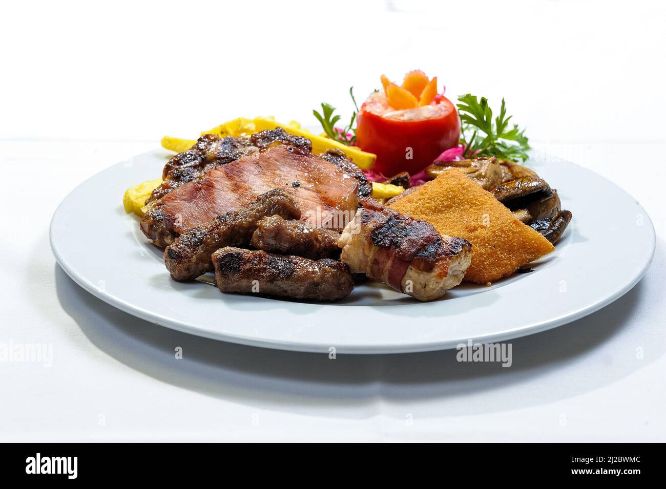 A different types of meat dishes on a white plate with white background