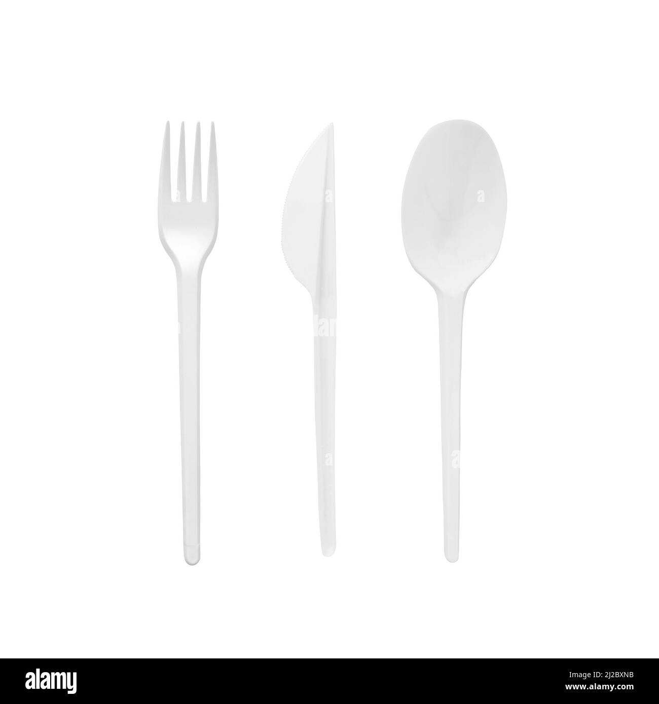 White plastic disposable spoon, fork and knife isolated on white background. Stock Photo