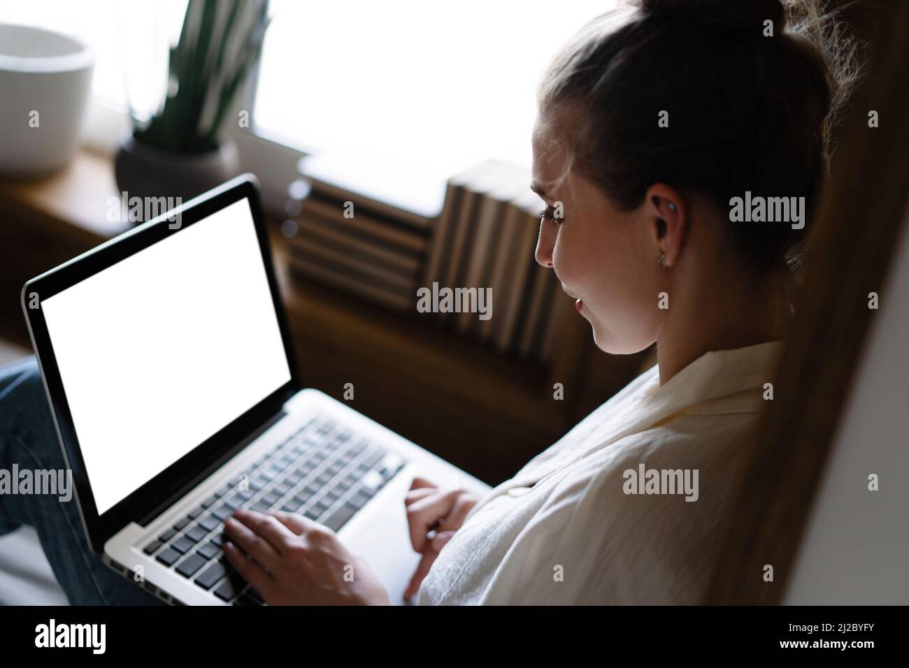 Mockup image of a woman using and typing on laptop computer keyboard ...